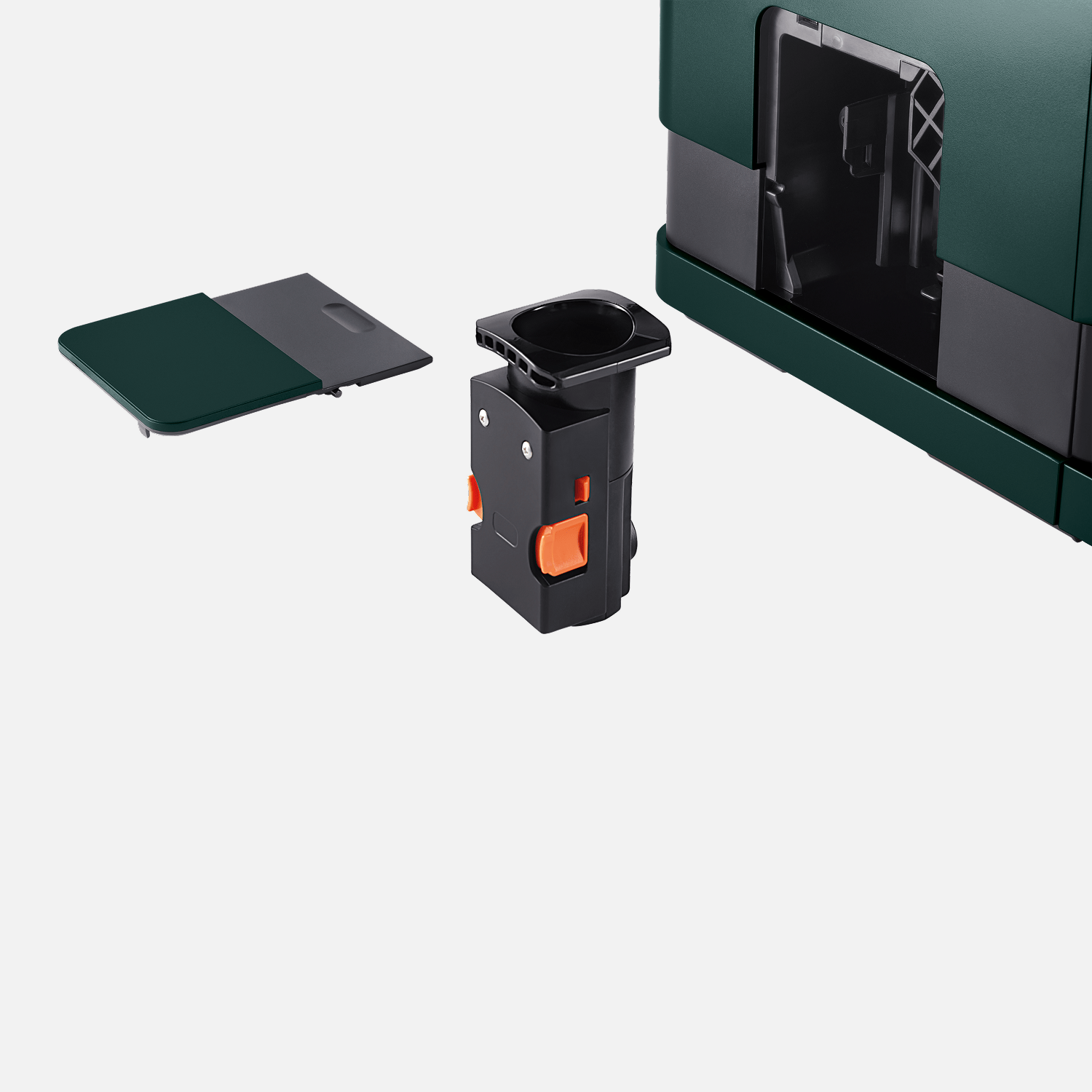 Nahaufnahme der Brühgruppe des Tchibo Esperto Caffè in Dark Green. Die Maschine ist im Hintergrund leicht erkennbar, und die abnehmbare Seitenklappe liegt daneben.